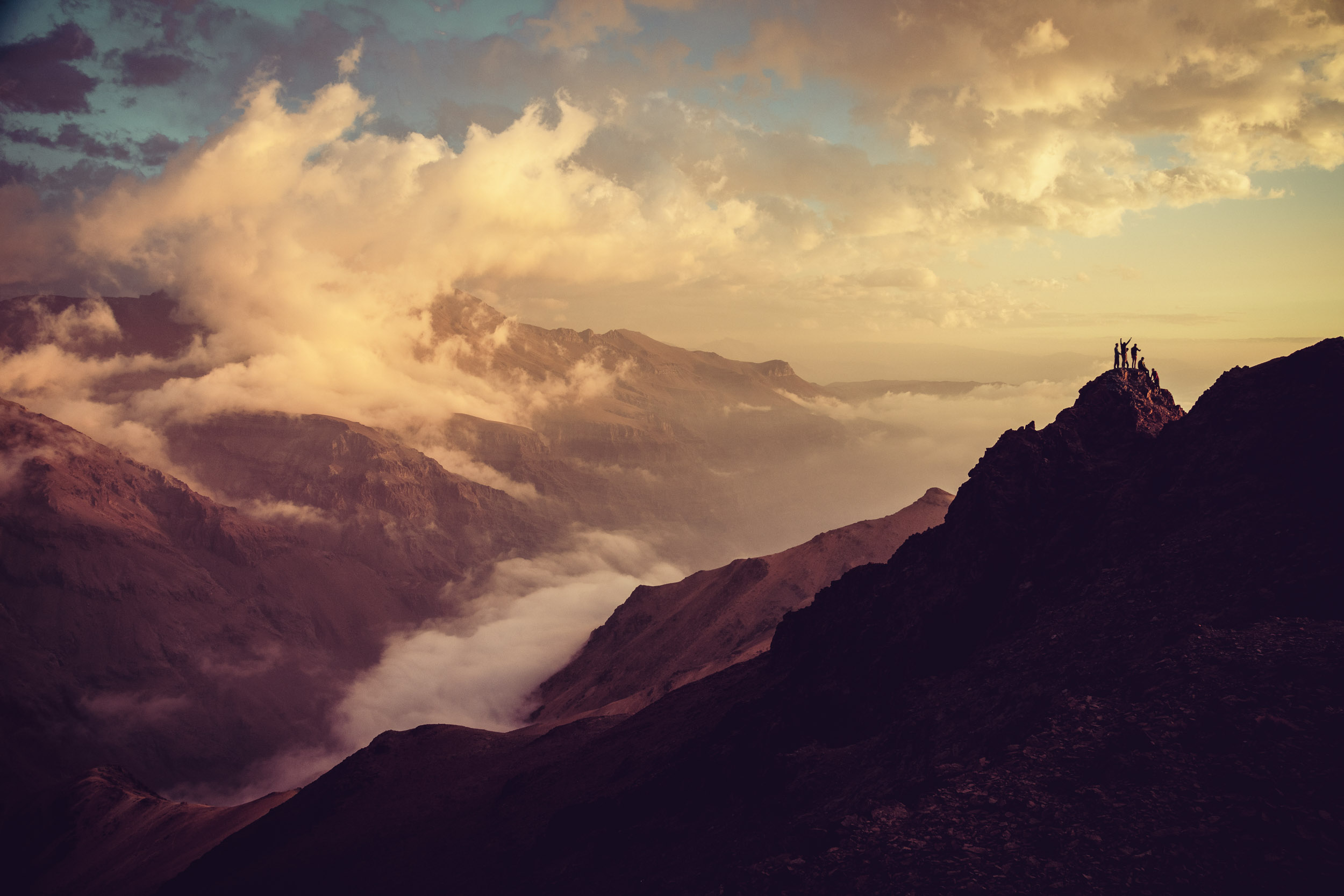 Hikers on the summit of an Andes peak at sunset