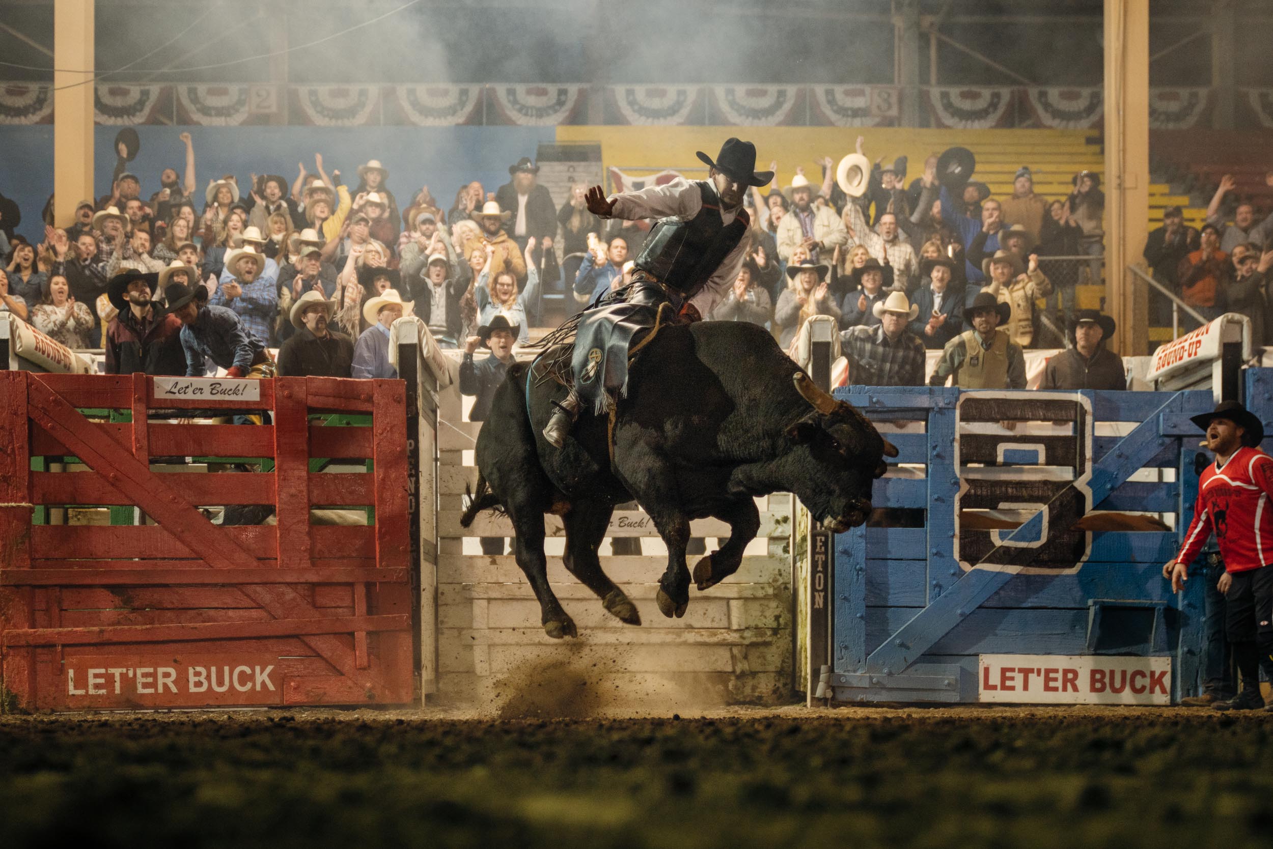 Pendleton Round Up Rodeo cowboy riding a black bull for 8 seconds