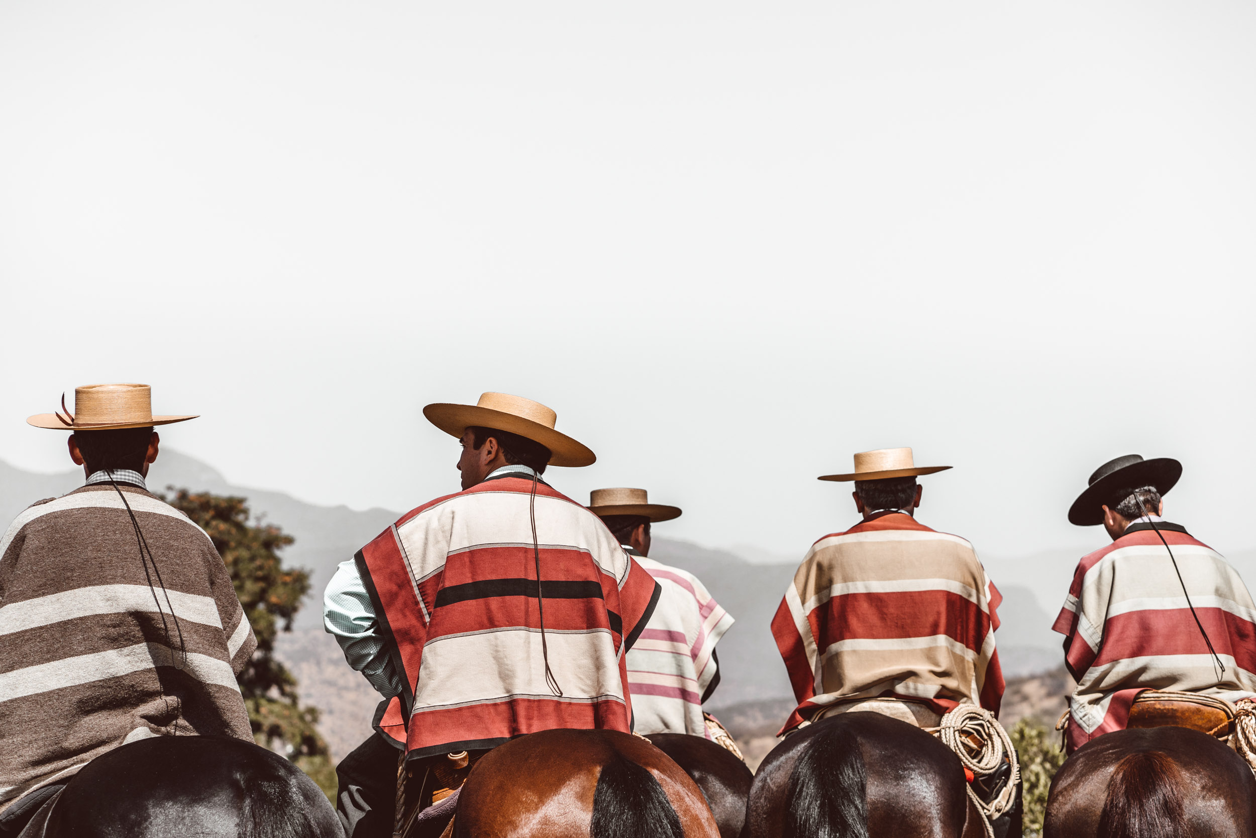 Chilean Huaso cowboys in their traditional attire seated on horseback